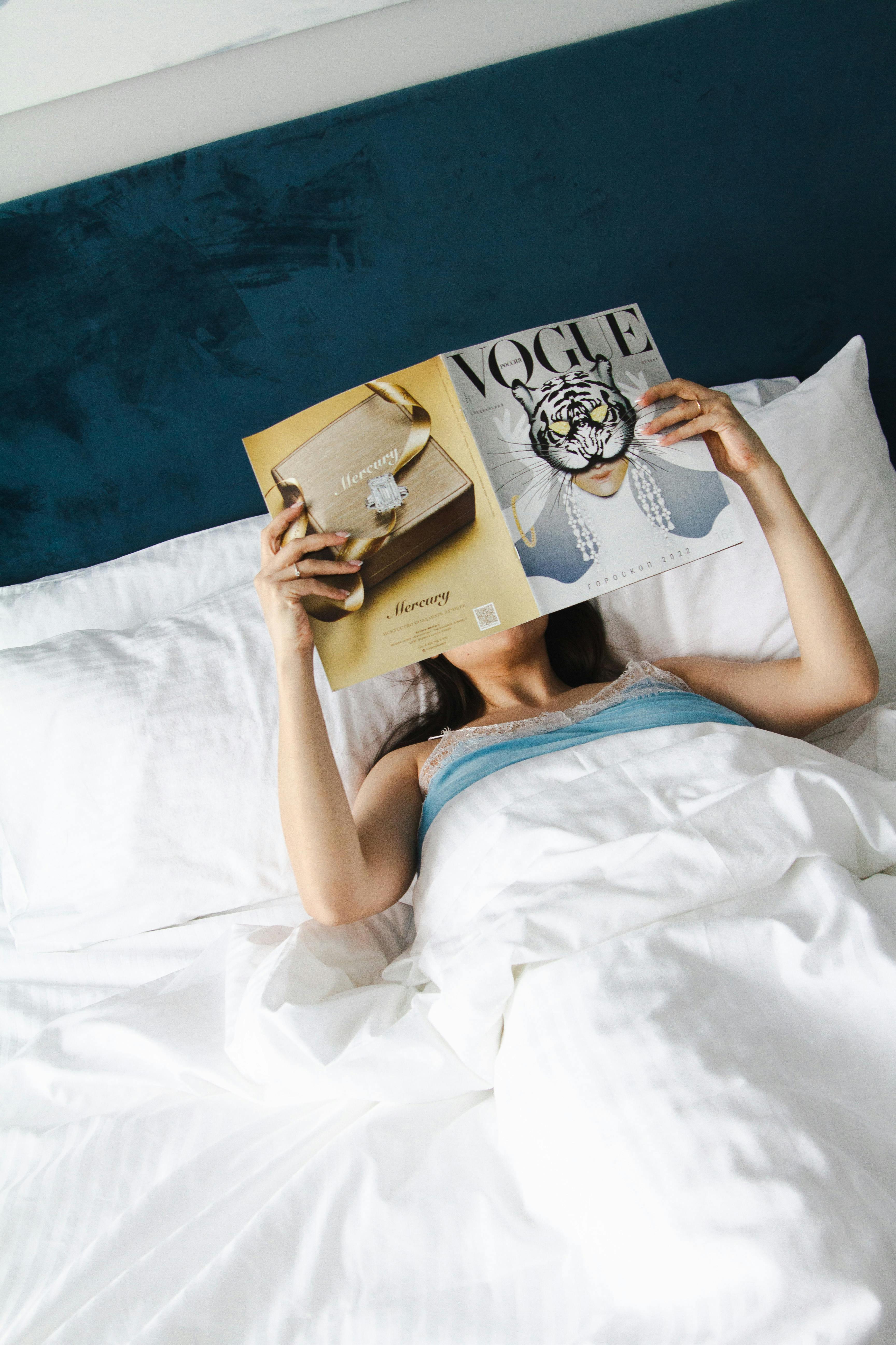 Relaxing morning in bed with Vogue magazine and coffee for a tranquil start to the day.