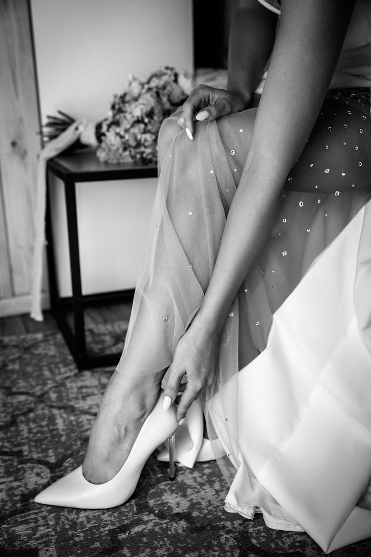 Bride Putting On White Heels