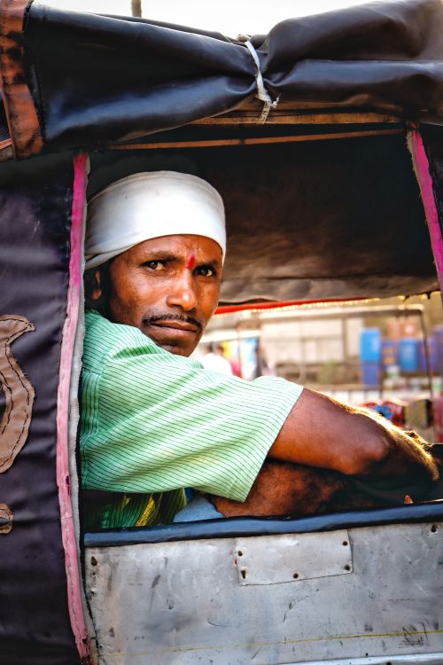 Free Close-up portrait of an Indian man in a vehicle in Nagpur, showcasing urban life. Stock Photo