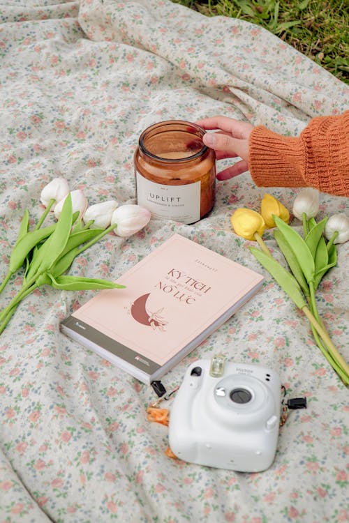 Hand Holding a Candle In Brown Glass Jar