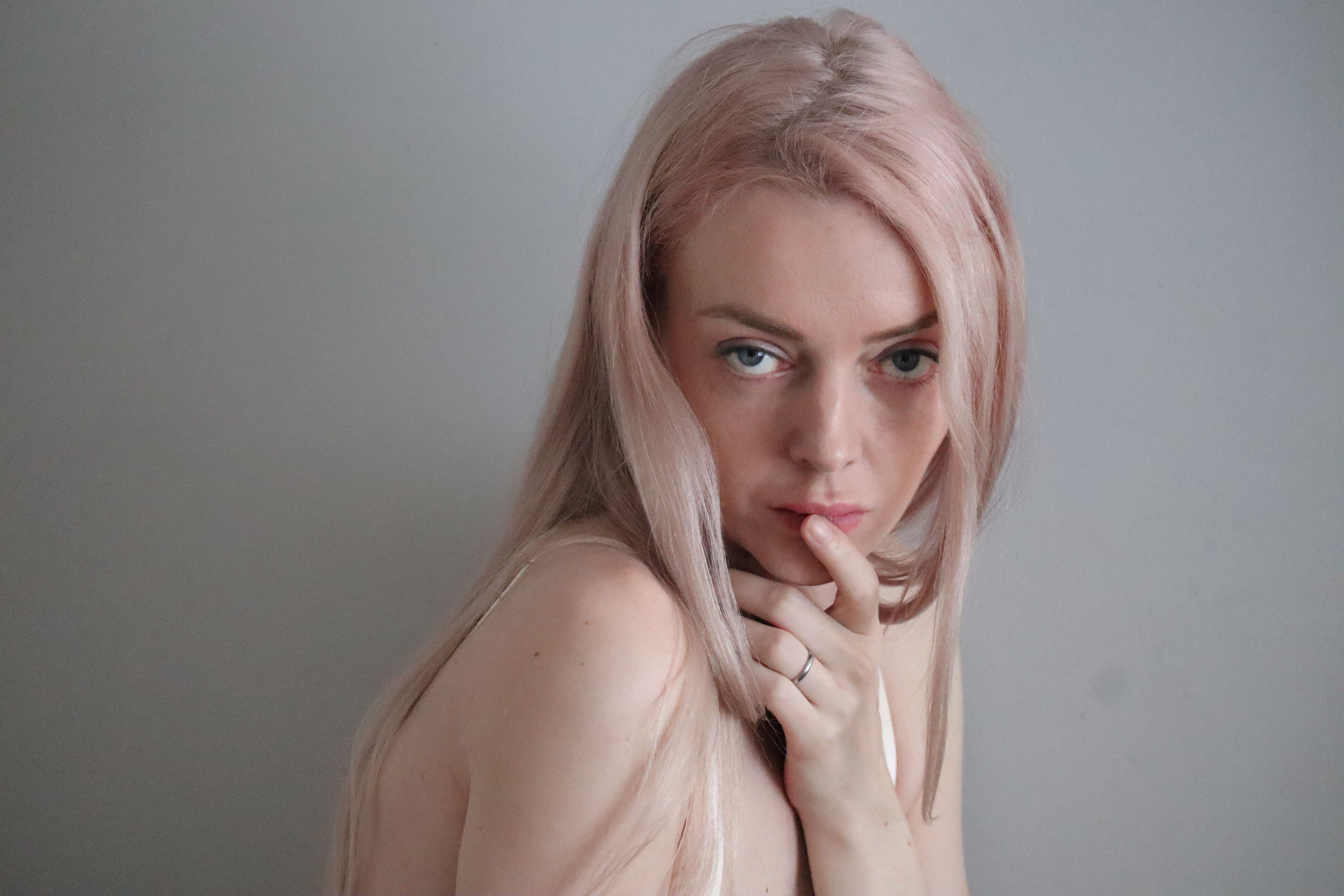 A captivating close-up portrait of a woman with blonde hair and a pensive expression.