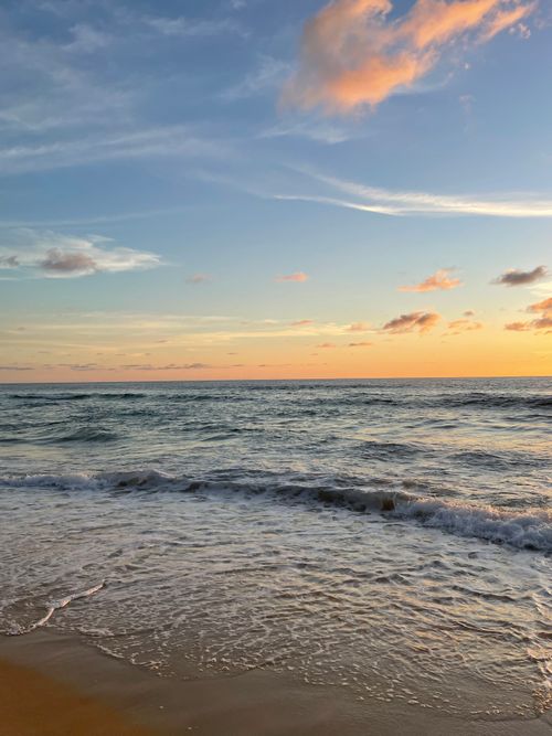 Free Peaceful sunset at Karon Beach, Thailand, capturing waves and a vibrant sky. Stock Photo