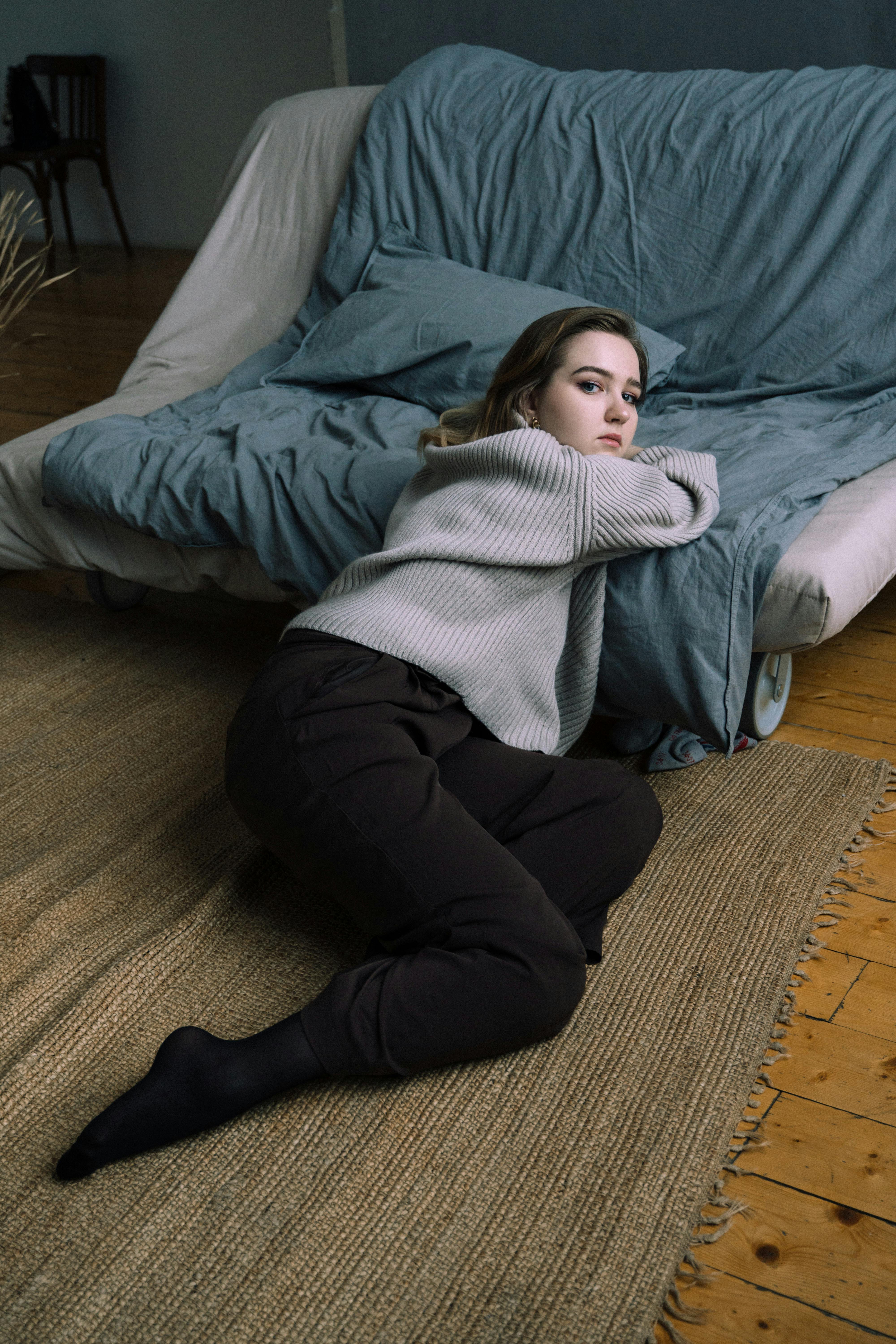 A Lovely Young Hispanic Woman Sitting In Gray Leggings An Brown