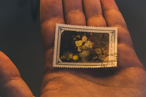 Free A Postage Stamp on a Hand  Stock Photo