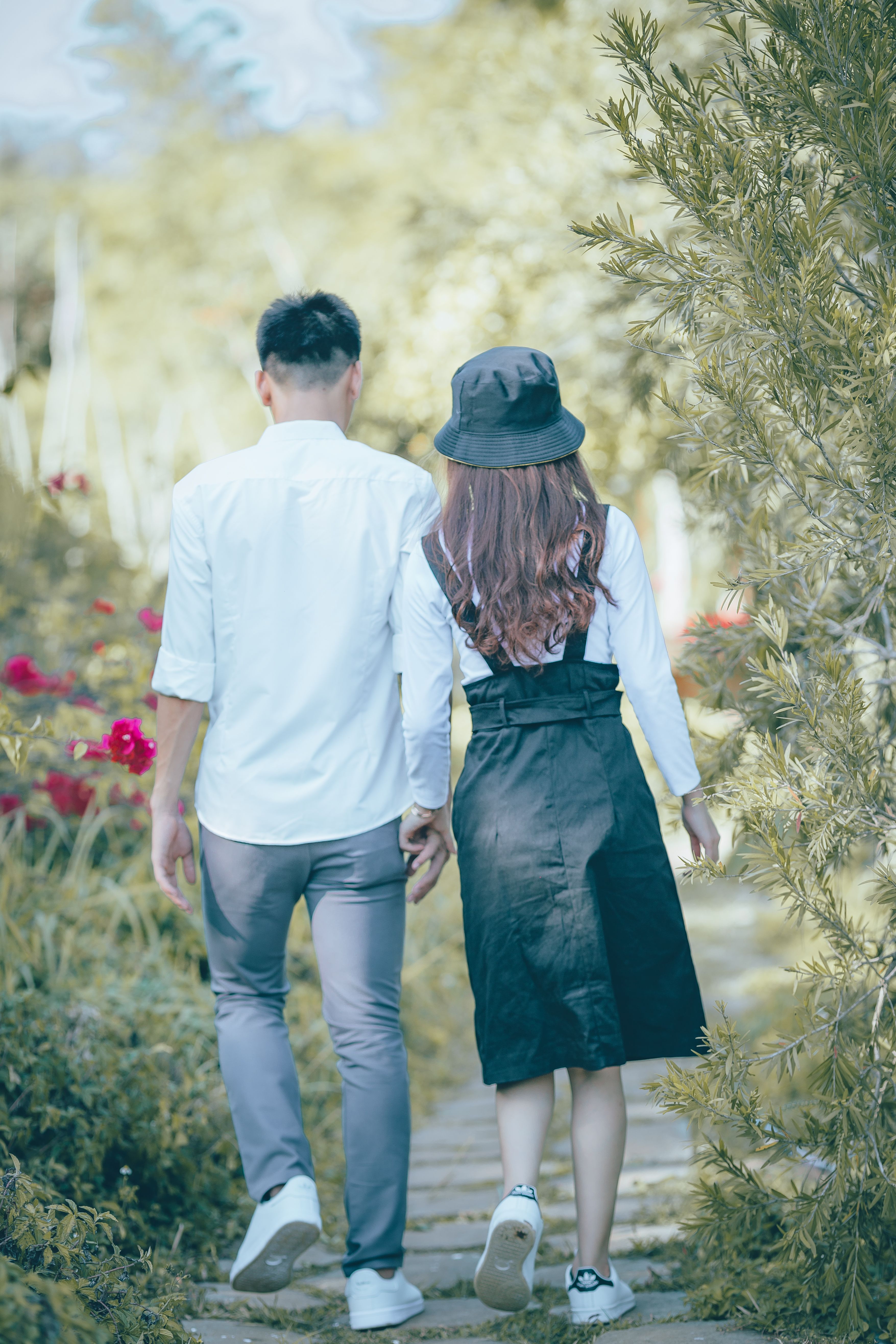 Back View of Couple Walking While Holding Hands · Free Stock Photo