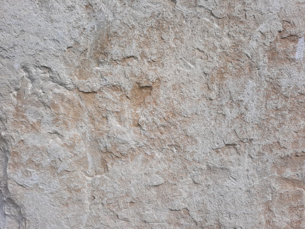 close up view of a textured concrete wall showcasing its rough surface