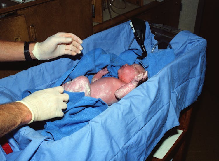 Newborn Baby In A Blue Textile