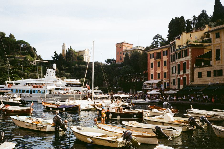 Picturesque view of a bustling Italian harbor with boats and vibrant buildings.