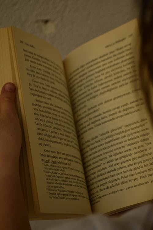A Person Holding an Open Book