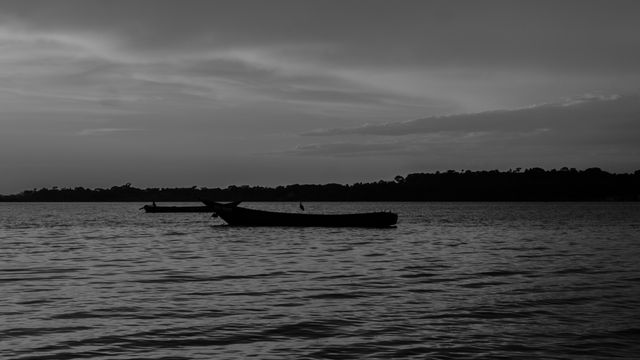 Black and white silhouette of boats on Lake Victoria during twilight, Entebbe, Uganda. — lounges at Entebbe Airport