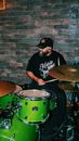 A Man Playing the Drums