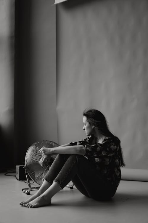 Monochrome Photo of Woman sitting on the Floor 