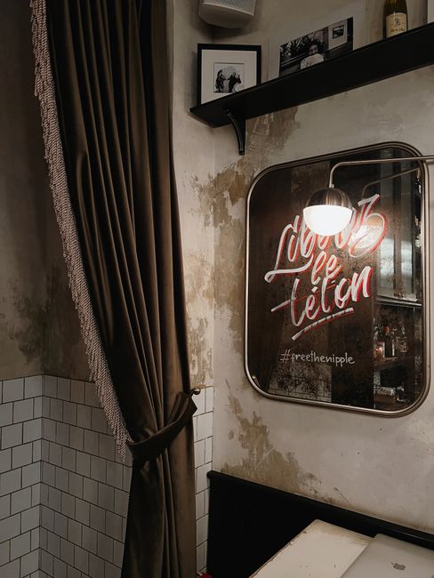 Stylish interior design featuring a mirror with unique text in a modern setting.