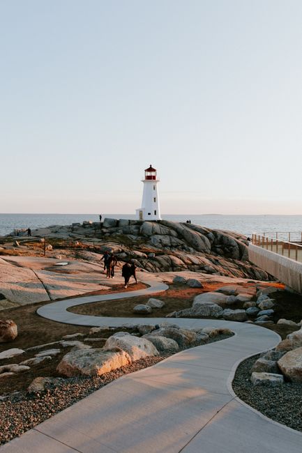 A winding pathway leads to the iconic Peggys Cove Lighthouse in Nova Scotia.
