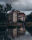 Brown and White Concrete Building Beside Body of Water