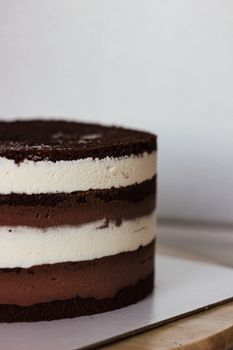 Close-up of a rich chocolate and cream layered cake, tempting indulgence.