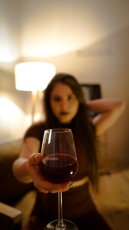 A Woman Holding a Glass of Red Wine 