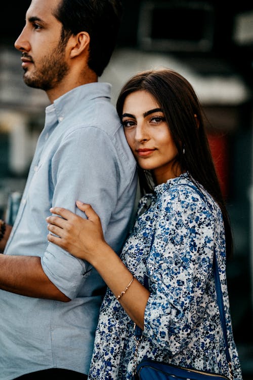 Woman Standing Behind Man and Embracing Him 