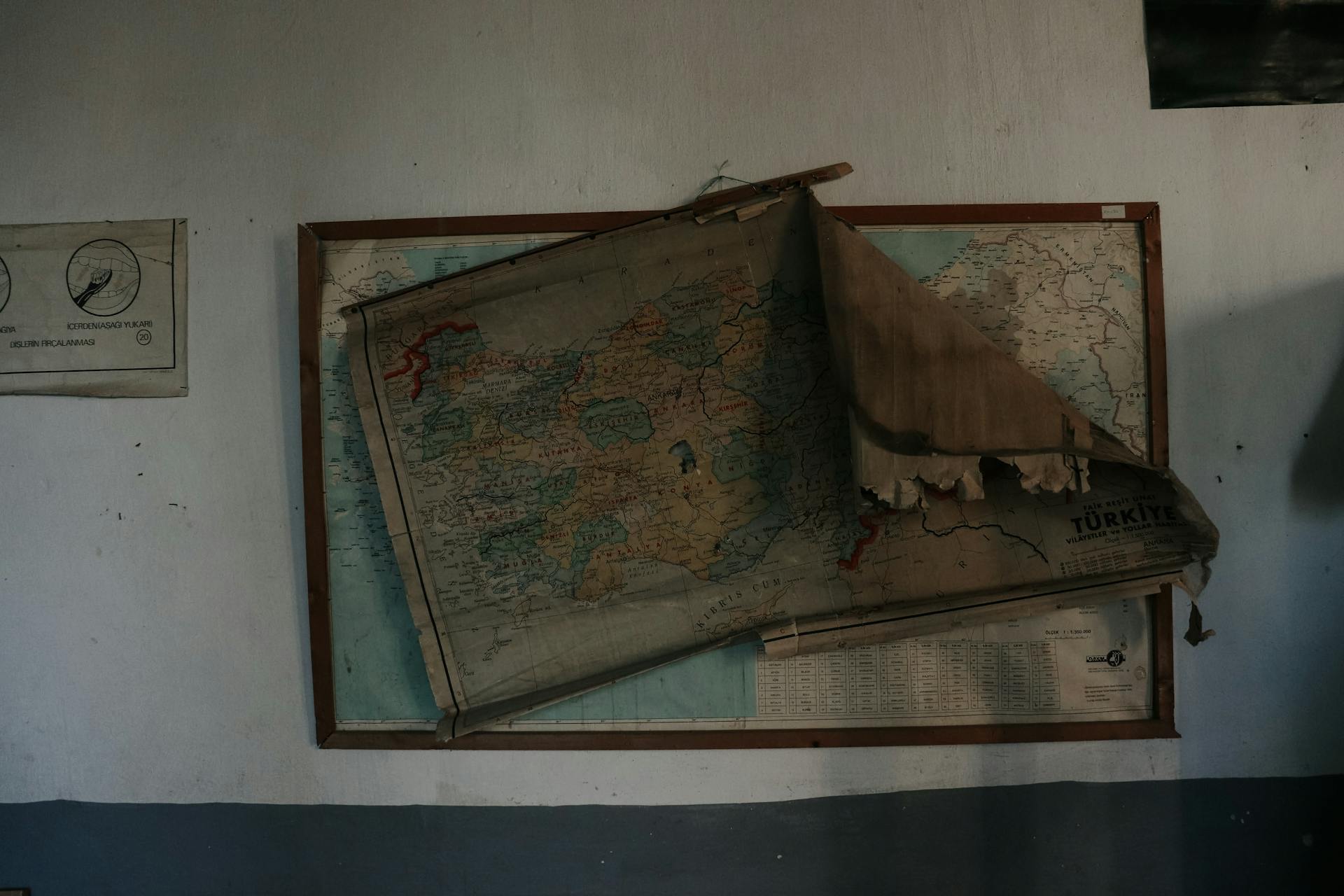 A vintage torn map displayed on a rustic wall evokes a historical feel.