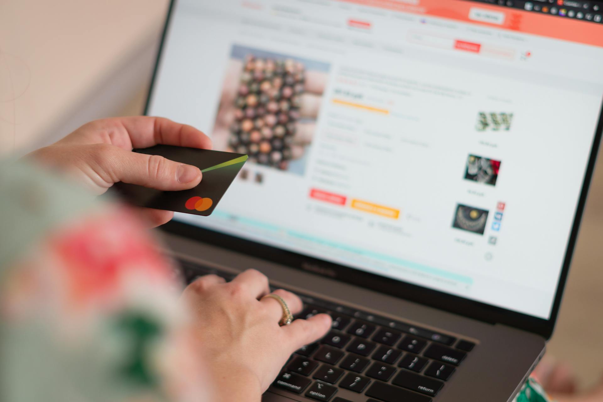 Engaging in online shopping using a credit card with a laptop for convenience and ease.