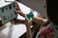 Person Holding Green and White Card