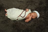 Baby in White Shirt Lying on White Textile