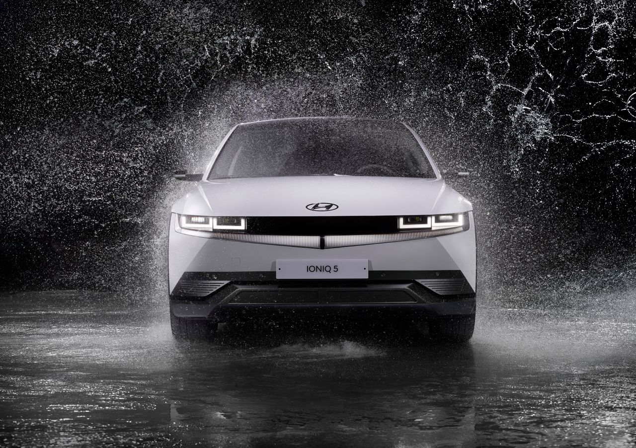 dynamic front view of a hyundai ioniq 5 splashing through rain capture