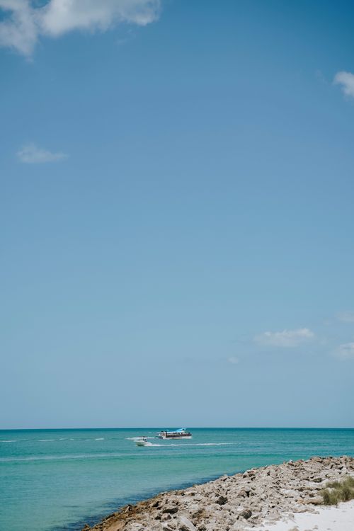Free Experience the tranquil beauty of Clearwater, FL with this scenic beach view featuring calm seas and blue skies. Stock Photo