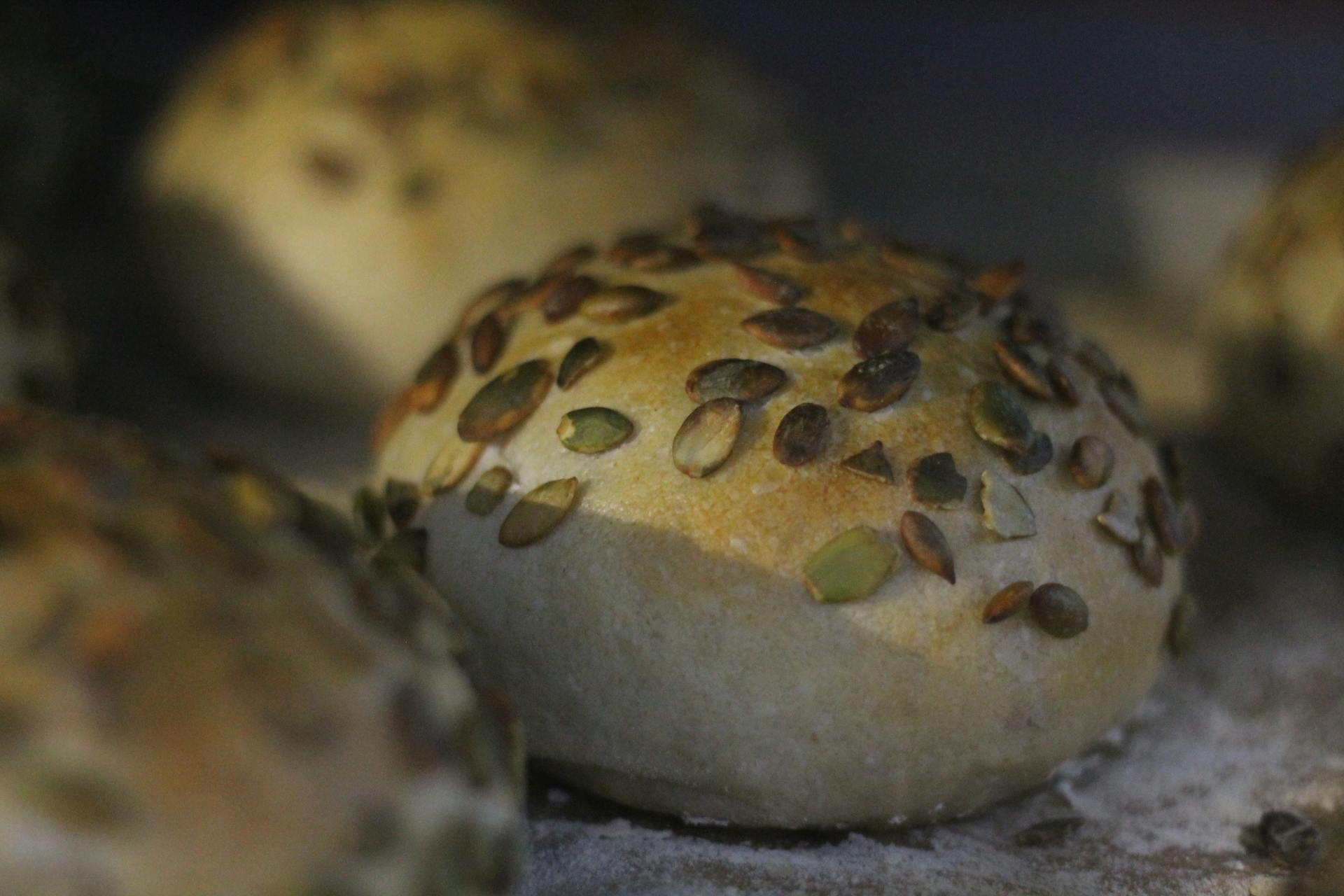 Freshly baked seeded bread rolls with a golden crust, perfect for culinary use.