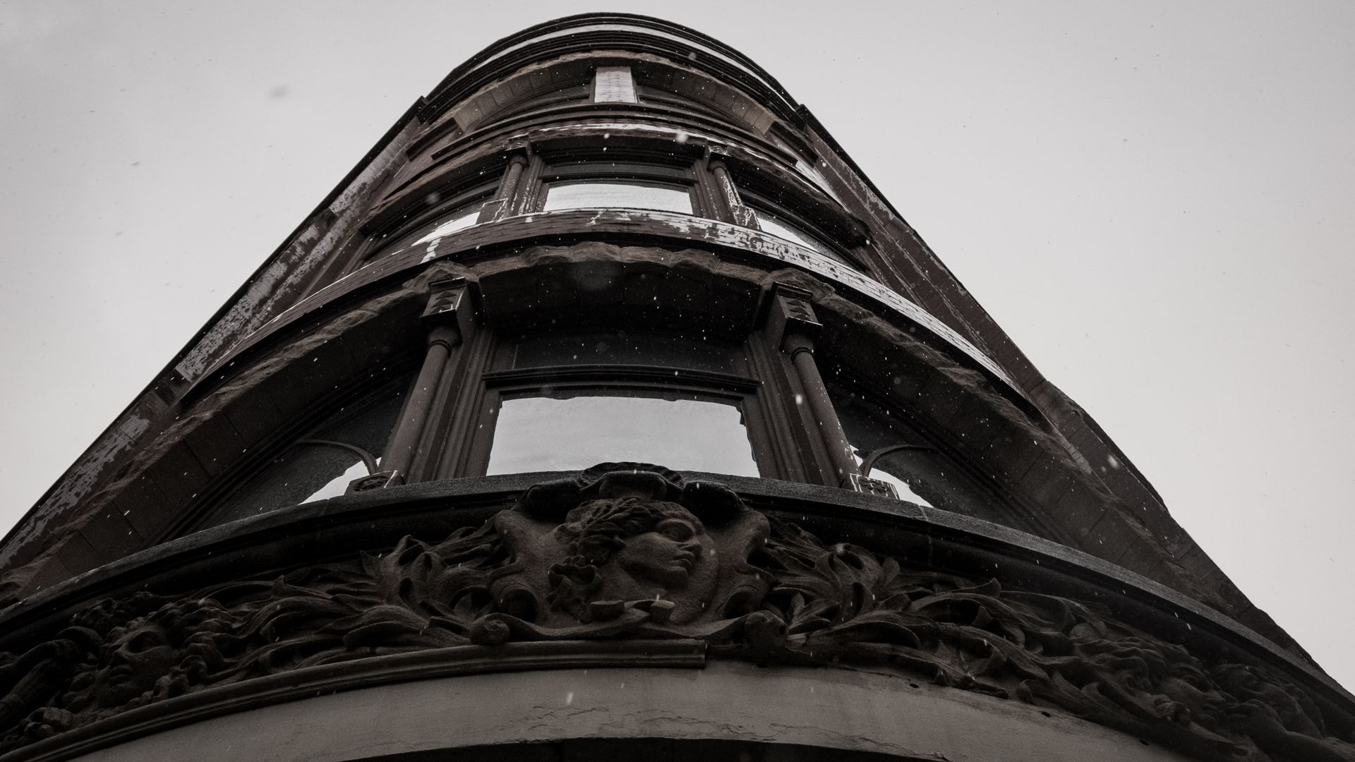 A striking low angle view of an old vintage building with intricate architectural details.