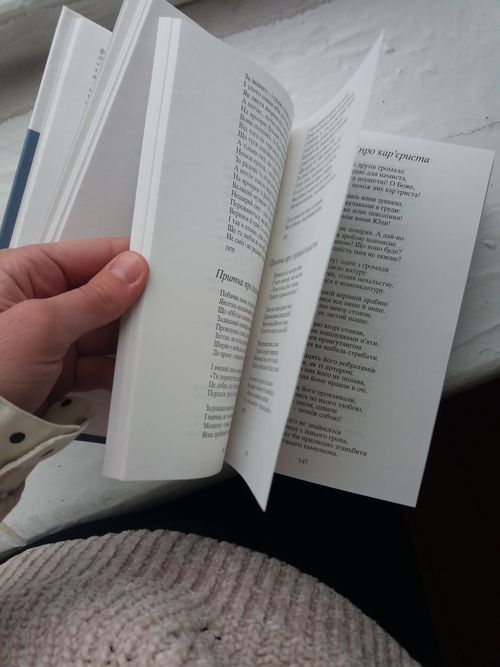 Free A person flipping through a book on a white surface, close-up view. Stock Photo