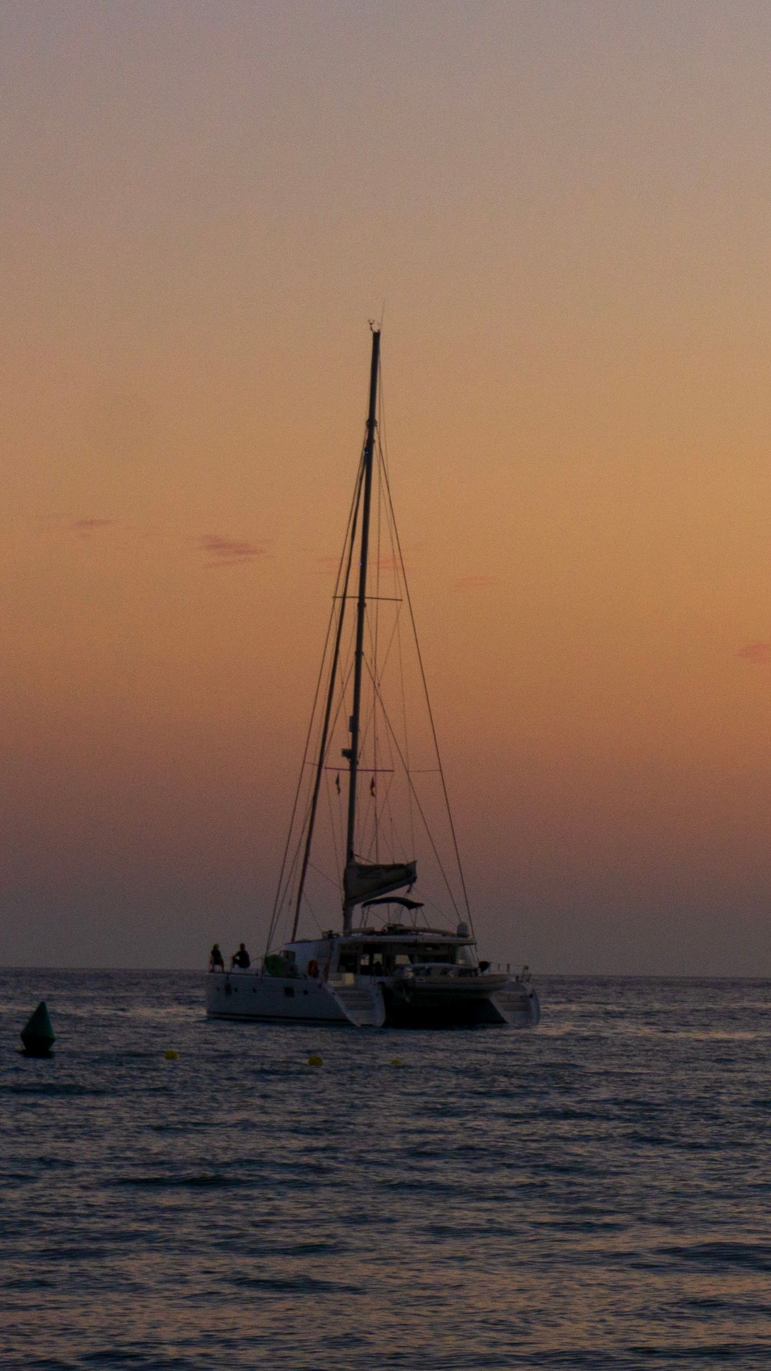 Yacht sailing at sunset