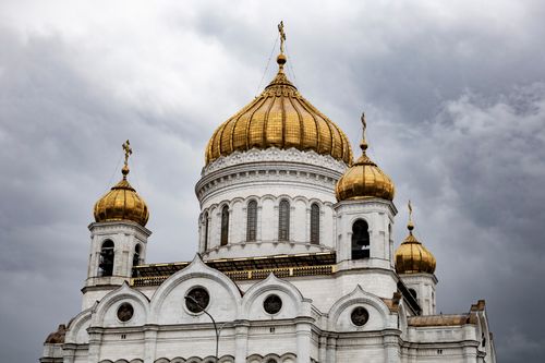 Free Iconic view of the Cathedral of Christ the Savior with its golden domes under a dramatic sky. Stock Photo
