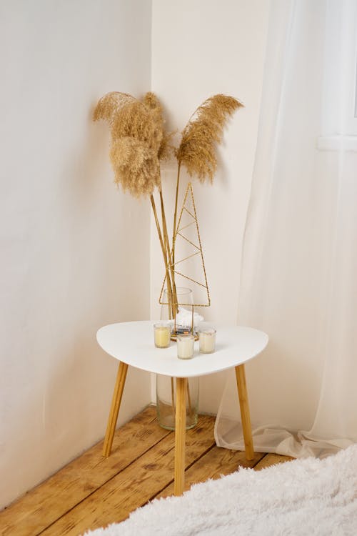 Coffee Table with Candles and Dry Grass Pieces in a Vase