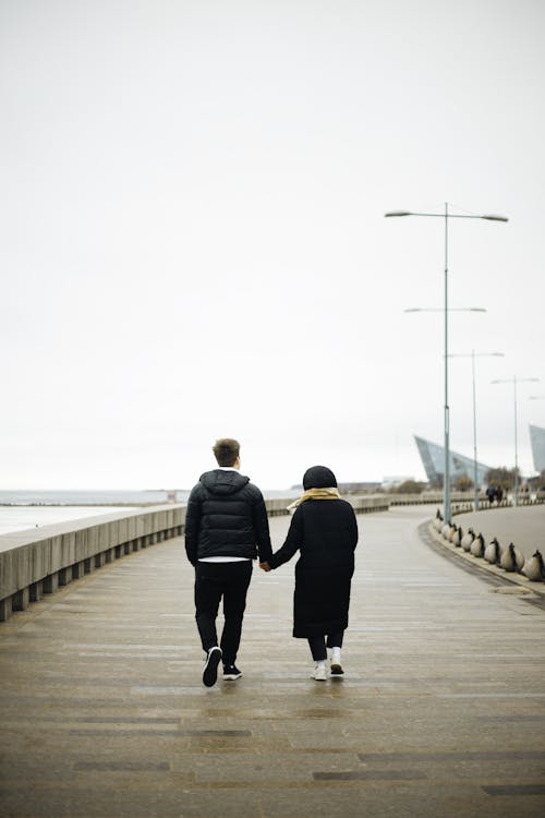 Free Couple Walking on a Wooden Pier  Stock Photo