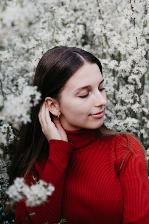 Woman Posing on the Background of a Blossoming Tree