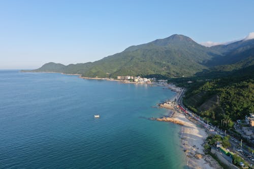 An Aerial Shot of a Coast with Mountains