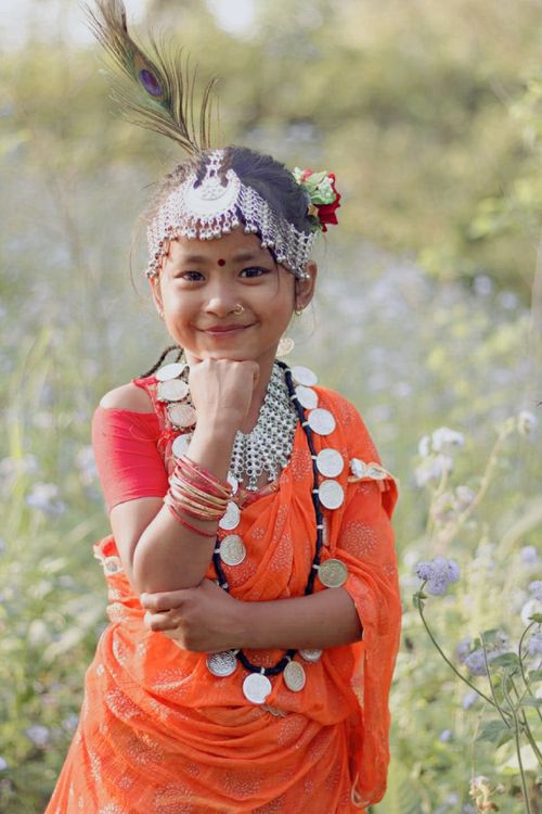 Free Charming portrait of a young girl wearing traditional clothing adorned with jewelry, outdoors. Stock Photo