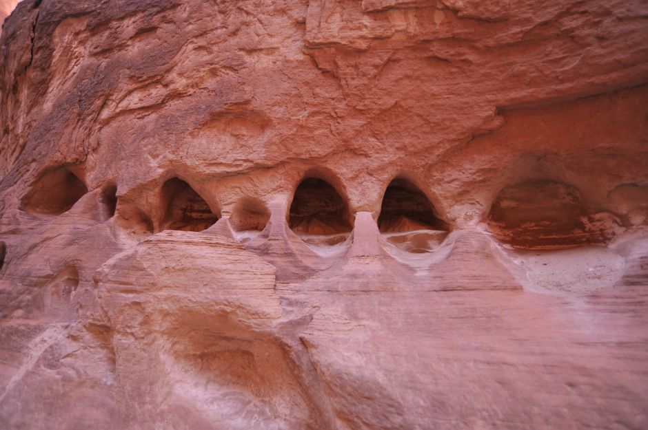 Close-up of unique erosion patterns on canyon walls, showcasing stunning geological formations.