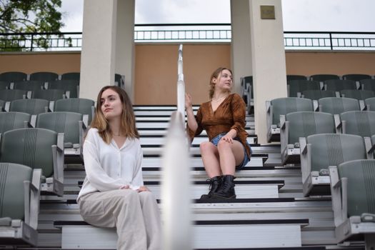 Women Sitting on the Bleacher Stairs