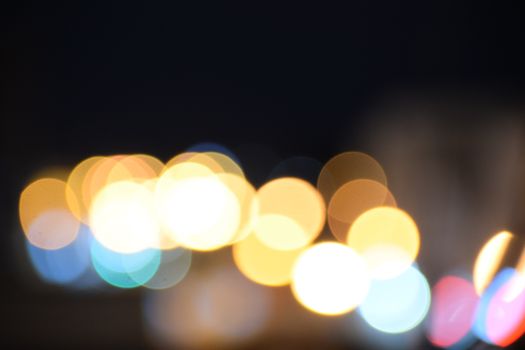 Colorful bokeh lights creating an abstract pattern against a dark backdrop.