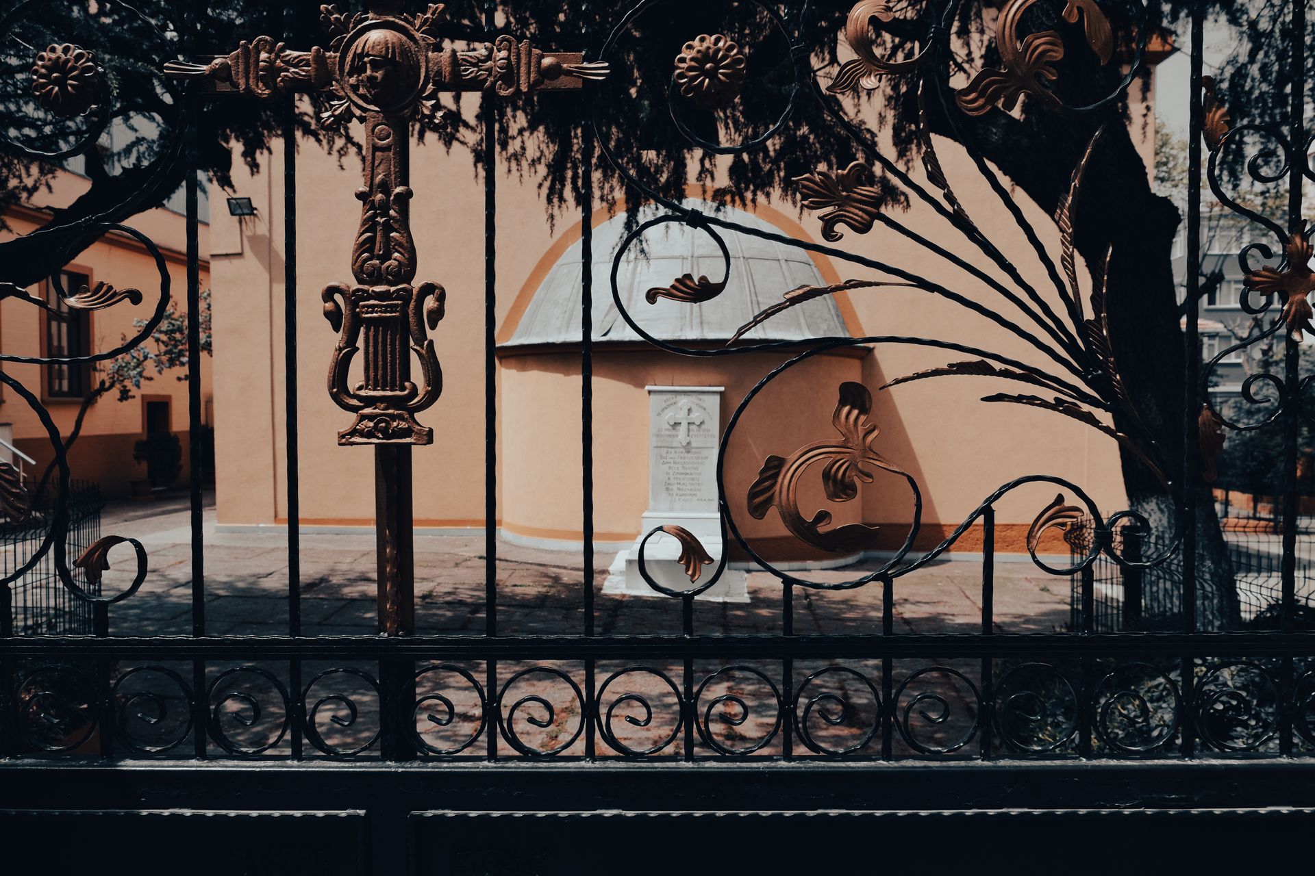 Intricately designed ironwork gate reveals a tombstone in Istanbul, Turkey.