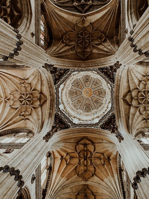 Free Stunning low-angle view of the ornate ceiling inside Salamanca Cathedral showcasing Gothic architecture. Stock Photo