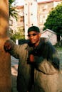 Man Posing in Between Blocks in City 