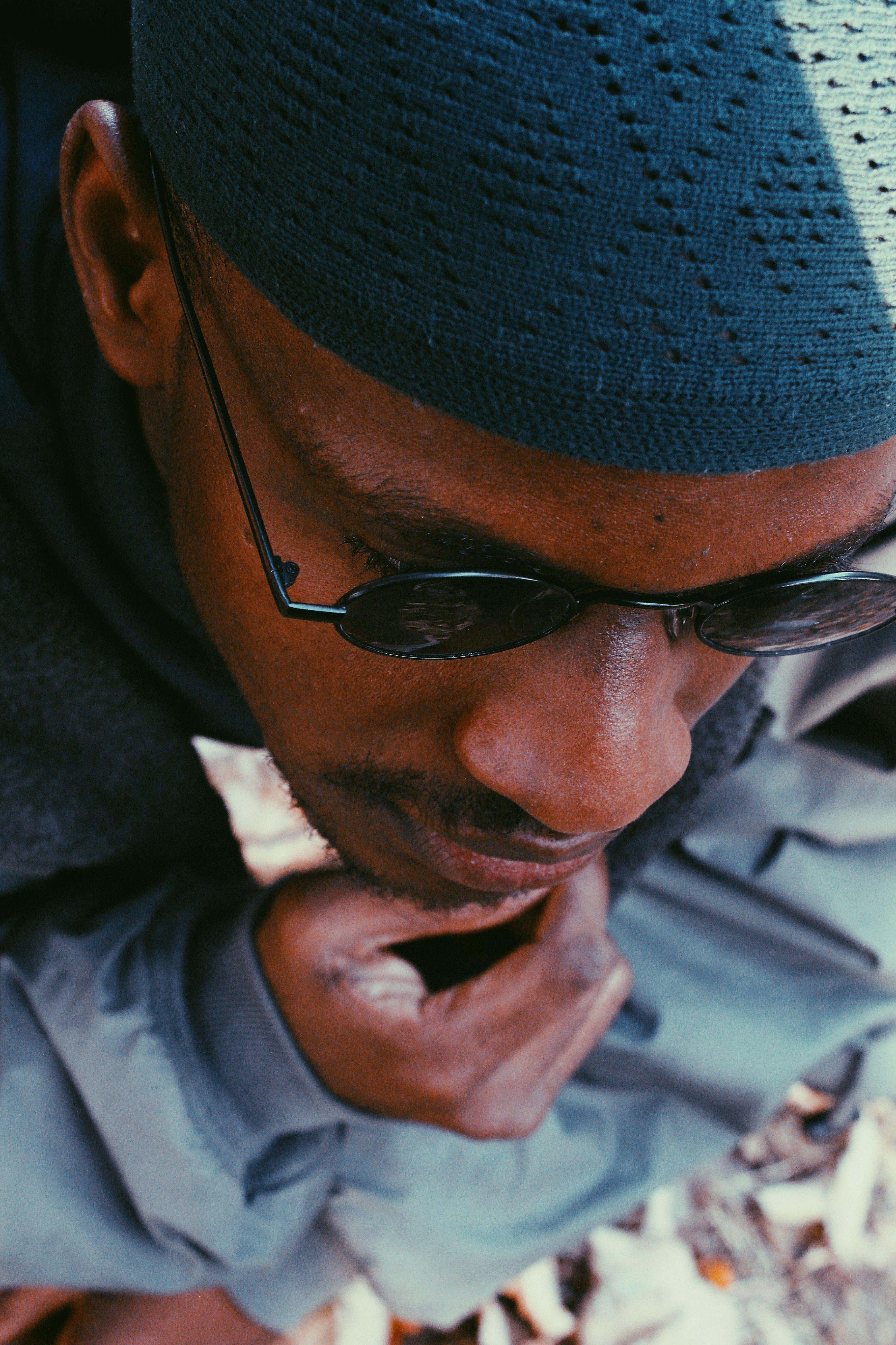 Close-up portrait of a man wearing sunglasses, showcasing thoughtful expression in Abuja, Nigeria.