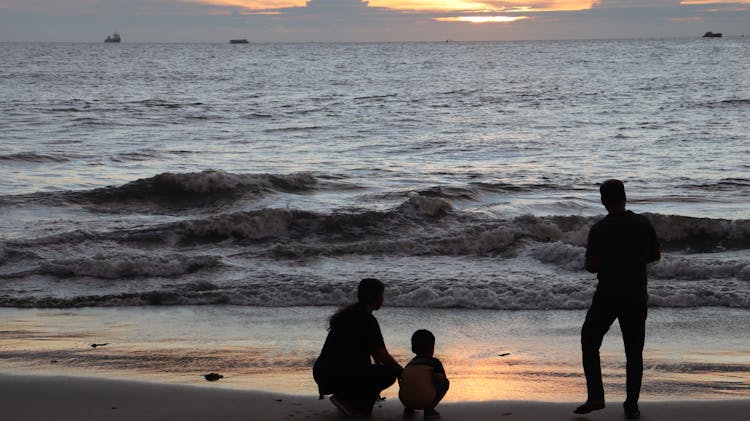 Silhouette Of Family On The Beach