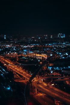 Stunning aerial cityscape of Moscow at night showcasing illuminated roads and buildings.