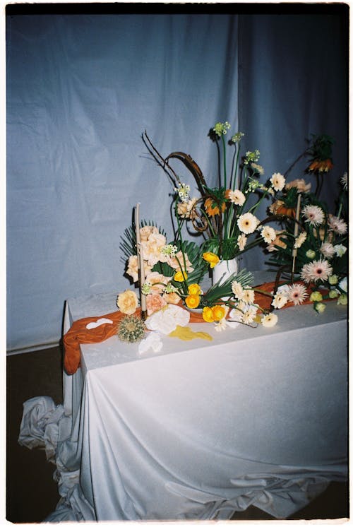 Flower Arrangement on a Table Covered with White Sheet