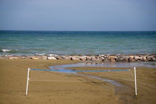 Photos gratuites de bord de l'océan, bord de mer, filet de volleyball