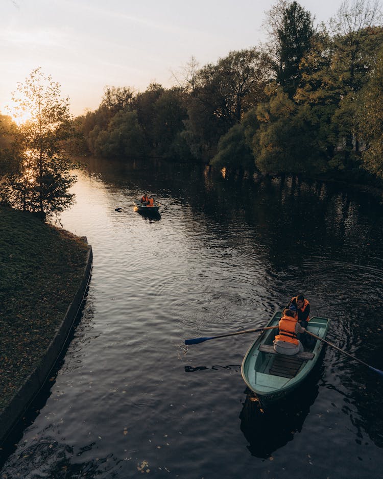 People Rowing In Boats Down The River